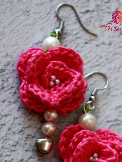 A detailed view of the layered petals on my pink rose crochet earrings.