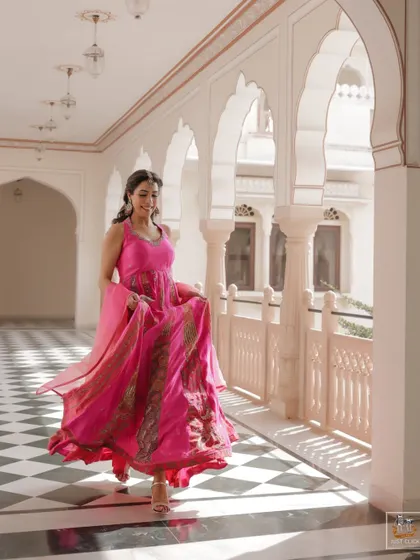 A motion shot of the bride walking down a palace hallway during her Mehndi.
