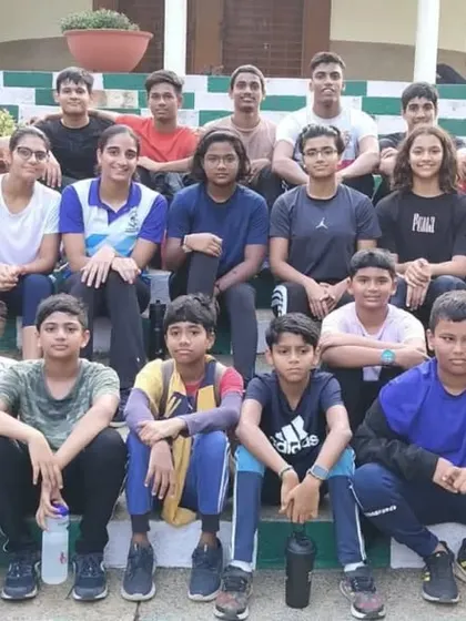 A group of my swimmers taking a moment to rest on the steps after a morning dryland session. Building a strong team bond is just as important as building physical strength.