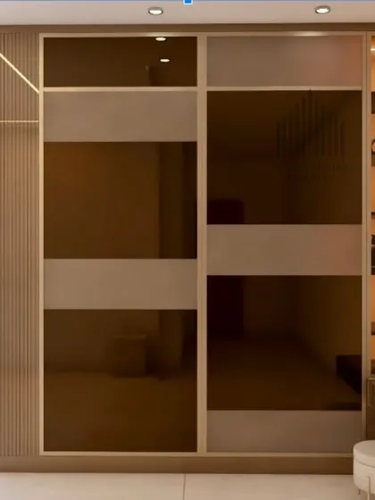 A sleek sliding wardrobe design with alternating frosted and tinted glass panels, complete with an attached dressing table with display shelves.
