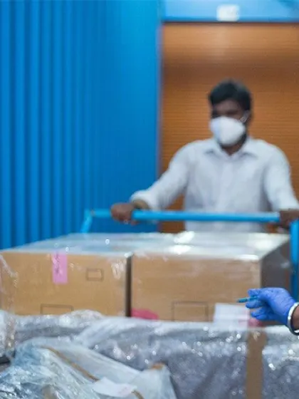 Our trained staff carefully handle your business goods. Here, a team member uses a trolley to safely transport boxes within the facility, demonstrating our commitment to protecting your items at every step.