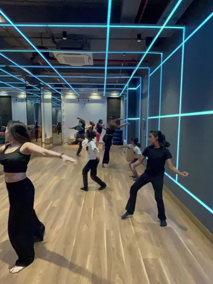 Students in a contemporary class practicing floor work and fluid movements. These exercises are fundamental to building a strong contemporary dance foundation.