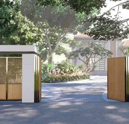 The entrance to this private villa features a modern gate crafted from wood and steel, set against a perforated jali wall that offers a hint of the vernacular charm within.