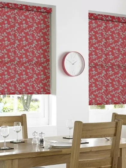 These red roller blinds with a subtle grey leaf pattern add a pop of color to this dining room. They are a great way to introduce color and design while maintaining a clean, modern look.