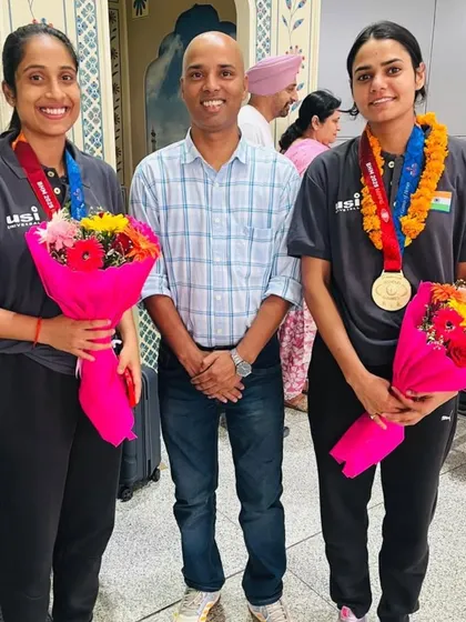 Our coach stands proudly with gold medalists Pooja and Khushboo Yadav upon their return. This moment celebrates not just the athletes, but the entire support system behind them.