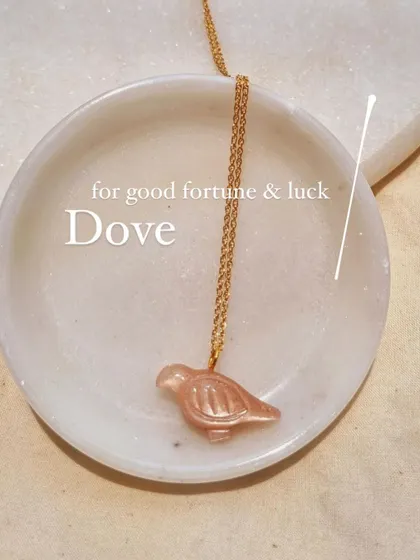 The Peach Moonstone Dove pendant, a beautiful charm for good fortune and luck.