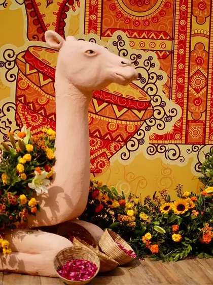 We love incorporating playful and thematic props. This life-sized camel sculpture, surrounded by a bed of marigolds and other flowers, was a popular and fun photo-op for guests.
