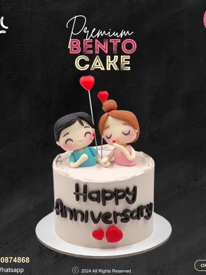 A premium bento cake to celebrate a happy anniversary. This sweet little cake is topped with an adorable fondant couple holding heart balloons, perfect for an intimate celebration.