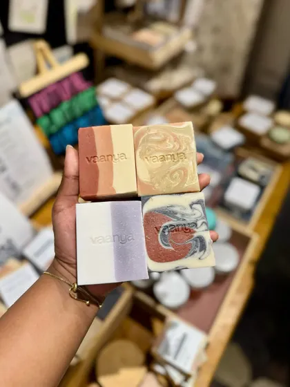 A shot of me holding some of our most popular soaps at a pop-up event. I love getting to meet our customers in person and share our products.