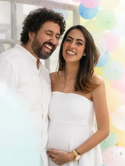 The happy couple sharing a laugh at their baby shower. My approach is to capture these candid moments of connection that truly reflect the joy of the occasion.