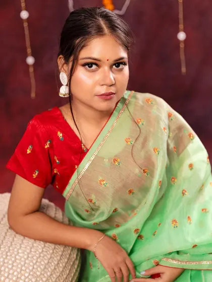 A happy and bright portrait from the Diwali shoot. The combination of festive lights, traditional attire, and a genuine smile creates a joyful and celebratory mood.