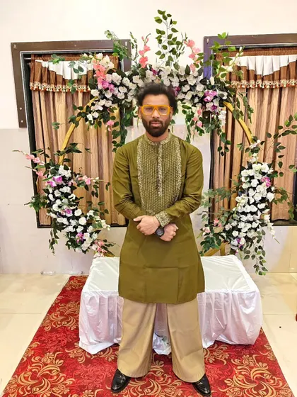I design some of my own clothes now. Showing off a custom-made olive green kurta.