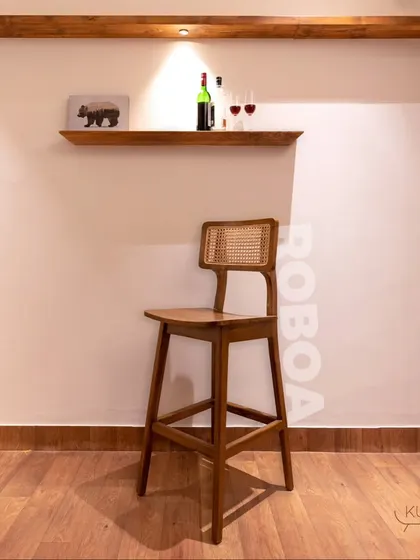 The 'Rooba' bar stool, the perfect chair for your breakfast counter or home bar. It features a solid teak frame and a comfortable rattan backrest.
