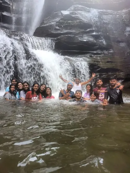 The entire group enjoying the waterfall. It's a celebration of completing the trek together.