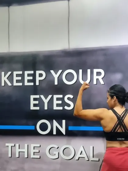 Progress is driven by focus. This pose highlights the bicep and shoulder definition that comes from dedicated strength work and a commitment to the process.