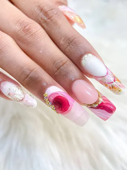 A full hand view of a creative set combining inbuilt florals, a 3D rose, marble effects, and crystal accents. We teach you how to mix and match techniques.