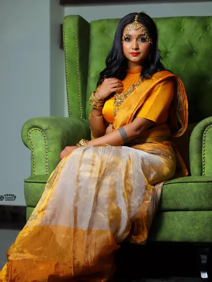 A regal pose in the yellow tissue silk half saree, showcasing a complete and elegant look.
