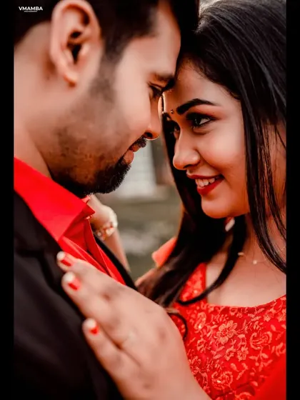 A close-up, intimate portrait focusing on the couple's connection. The vibrant red outfits add a touch of passion to this pre-wedding photo.