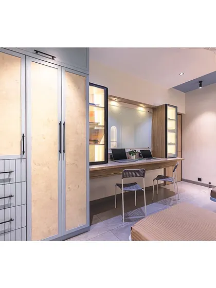 This view shows the full length of the room, highlighting the smart space planning that accommodates two beds, a large wardrobe, and a double study station without feeling cramped.