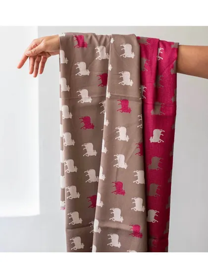 The 'Pinjori' fabric features rows of Pichwai cows, a classic Indian motif. Available in vibrant colourways, it's a playful and culturally rich choice for upholstery, drapery, or even framed as wall art.
