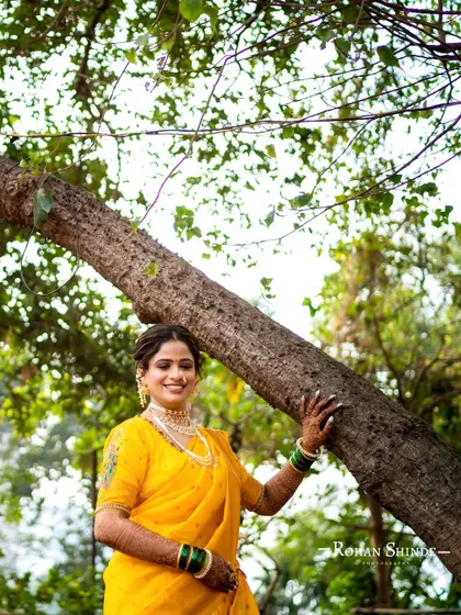 A professionally shot photo of the same yellow Navari look, capturing the beautiful details of the makeup and outfit in the natural outdoor setting.