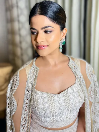 This angle highlights her radiant complexion and the clean, sophisticated feel of the overall look.