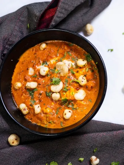 For a unique and wholesome vegetarian curry, I recommend the Paneer Makhana Masala. It combines soft paneer cubes and crispy fox nuts in a rich, velvety gravy.