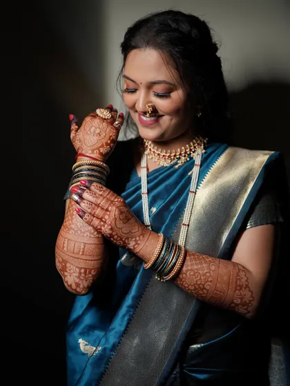 This close-up shows the intricate henna and the bride's glowing makeup. I focus on creating a look that complements all the beautiful details of a bride's attire.