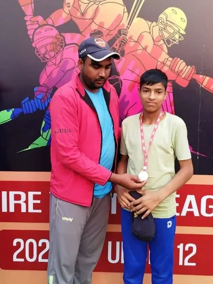A player receiving his medal at the presentation ceremony. Every participant is recognized for their effort.
