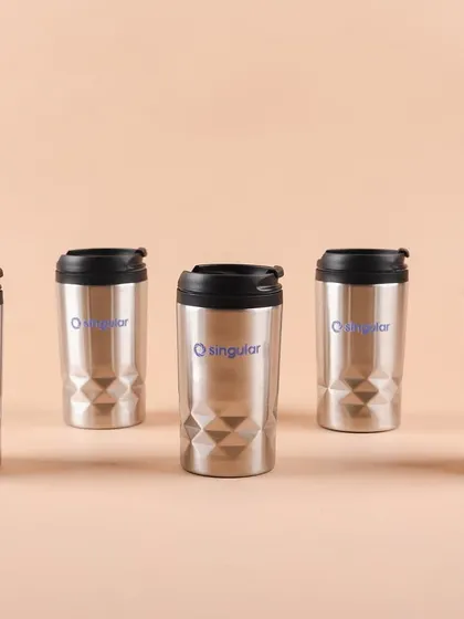 A lineup of the sleek, geometric-patterned stainless steel tumblers we sourced and branded for Singular's employee kits.