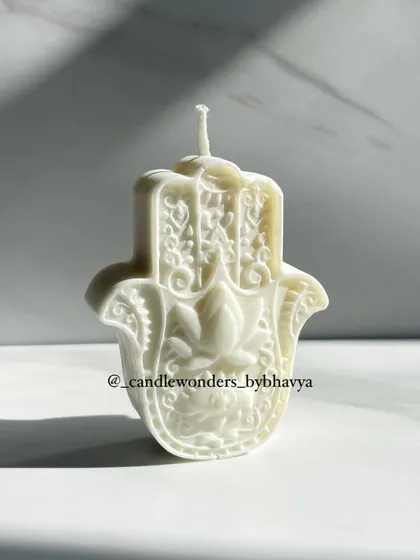 A minimalist white Hamsa Hand candle, perfect for any decor style.