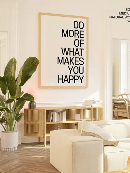 Let your walls speak with this bold typographic art. The "Do More of What Makes You Happy" quote, presented in a large format with a simple natural wood frame, serves as a daily dose of inspiration for your home or office.