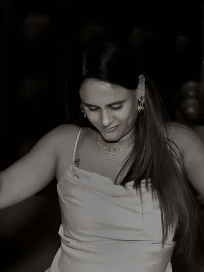 I love using black and white to highlight the emotion and energy of a moment. This candid photo captures a guest dancing freely at a birthday party, focusing on her expression and movement without the distraction of color.