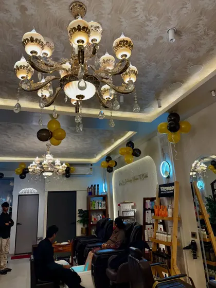 Our pedicure and hair wash area is designed for relaxation. You can see the elegant chandeliers and comfortable seating that make every service feel like a pampering session.