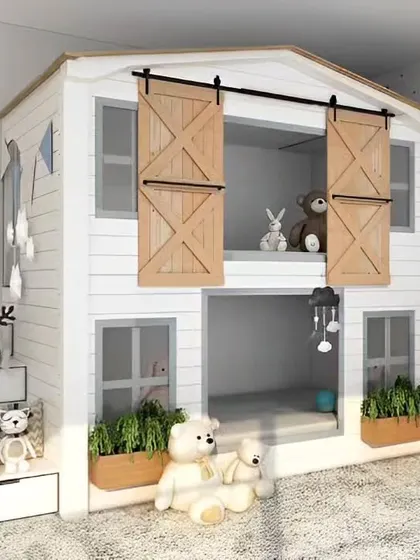 We built this amazing two-story playhouse bed for a child's room. The design features a lower bunk for sleeping and an upper loft area for playing, complete with charming barn doors.