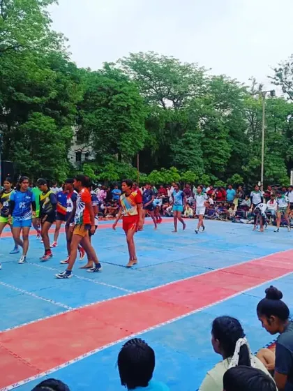 A girls' kabaddi match in progress on a mat court. We provide training and opportunities for our players on both mud and mat surfaces.