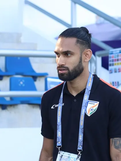 A candid moment on the sidelines during a national team camp. As a coach, being present and observant is key to understanding the team's dynamics and individual player needs.