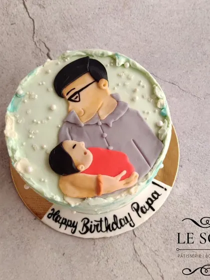 A special cake for a new dad's first birthday as a papa. This half-kg Chocolate Butterscotch cake features a heartwarming 2D fondant portrait of the father and his new baby.
