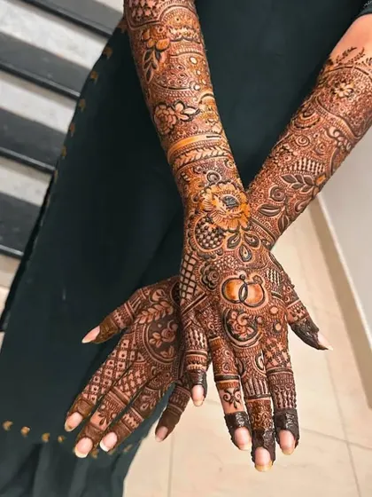 Nihal's beautiful bridal mehndi, featuring personalized ring symbols and intricate patterns. A design fit for a queen on her special day.