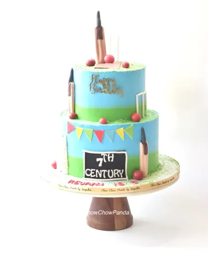 A clear, straight-on shot of the two-tier cricket cake.
