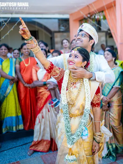 A joyous moment as the newly married couple looks towards their future together, surrounded by the love of their family and friends.