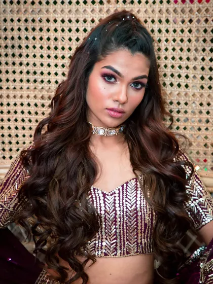 A close-up of a royal and glamorous look. I created a bold, smokey eye with purple hues to match the lehenga, paired with a matte nude lip and perfectly sculpted brows for a high-impact finish.