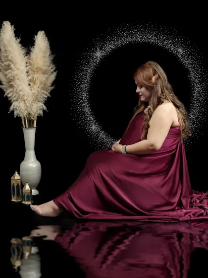 Dramatic and artistic portraits using a deep maroon fabric. I use creative lighting and reflection effects to craft these unique, fine-art maternity images.