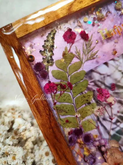 Detail of the preserved fern and other delicate florals, showing the careful layering and composition of the anniversary frame.