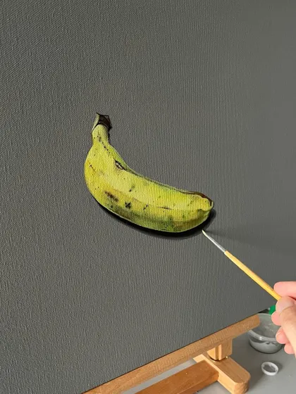 A realistic painting of a single banana on canvas. Using acrylics, I built up the colors to capture the subtle texture and coloration of the banana peel.