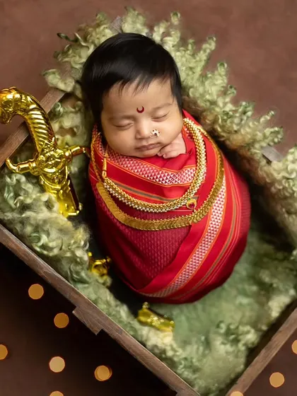 A top-down perspective of the baby in the crate, giving a full view of the setup and the beautiful contrast of colors and textures.