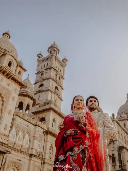 A low-angle shot that makes the couple and the palace look even more grand and epic.
