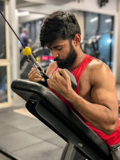 "Sweat, sacrifice, success." A preacher curl with a cable machine, providing constant tension on the bicep.