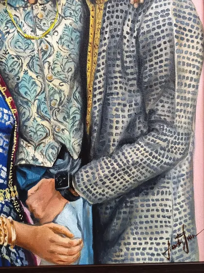 A detail shot of the intricate patterns on the father's and son's kurtas.