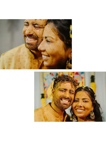 A close-up of the couple, their faces covered in turmeric, sharing a radiant, happy smile.
